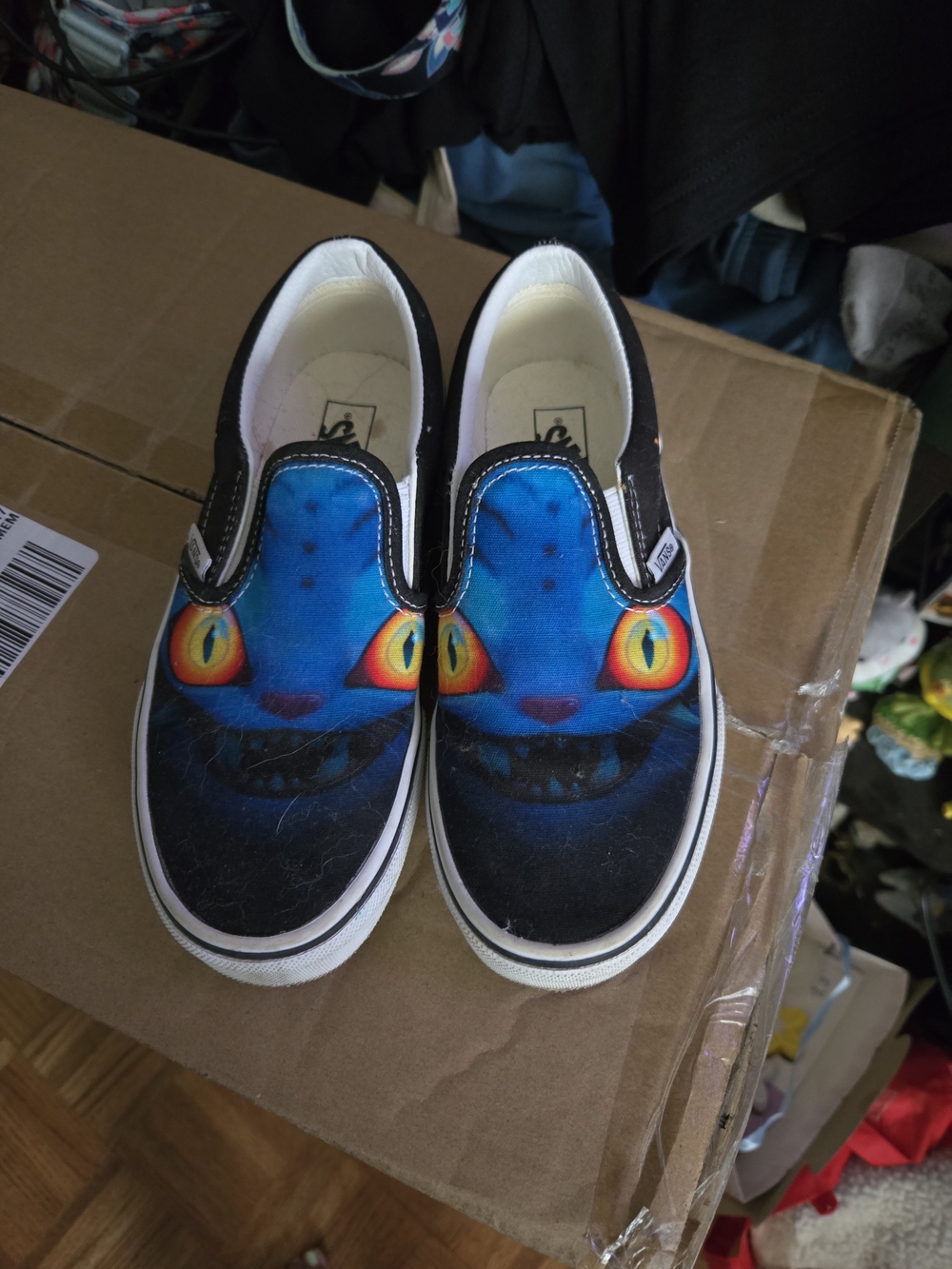 Vans Kids Blue Cheshire Cat Slip-On Sneakers with Yellow-Orange Eyes